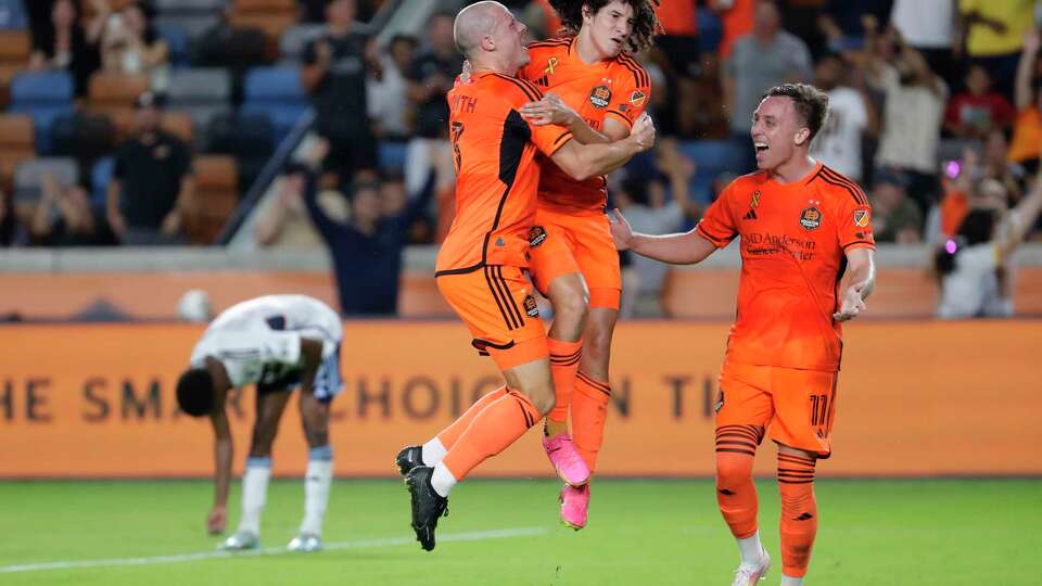 Houston Dynamo's Brad Smith, Ivan Franco and Corey Baird, from left, celebrate a goal by Franco against the Vancouver Whitecaps during the second half of an MLS soccer match Wednesday, Sept. 20, 2023, in Houston. (AP Photo/Michael Wyke)