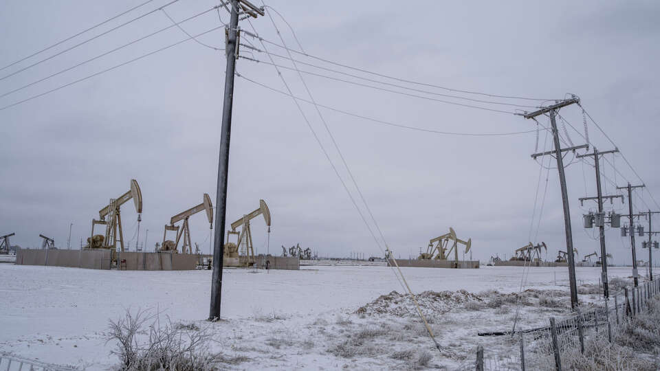 Pumpjacks and power lines in the snowy Permian Basin in early 2021. The Texas power grid operator's new assessment of supply for October and November suggests Texans will get a break from the worry of grid failure they lived with this summer. But a worrisome winter looms.