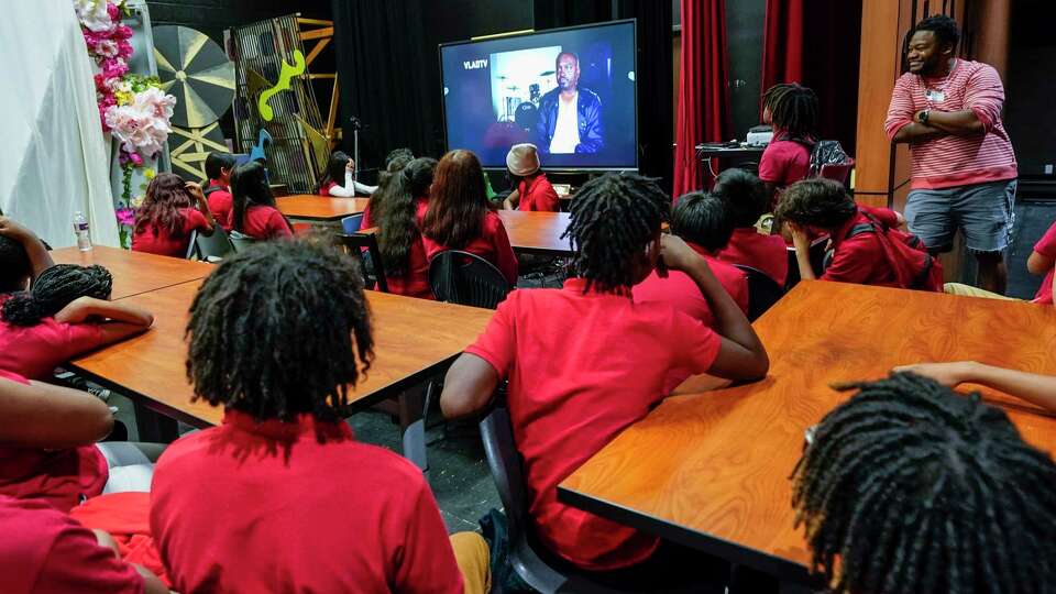 James Buchanan, a DJ, shows a video to students during a music DYAD class at Lawson Middle School on Thursday, Sept. 21, 2023 in Houston. Houston ISD state-appointed superintendent Mike Miles introduced the DYAD program at the district's schools this year, where contractors come to the school to teach programs like photography, gardening, boxing, golf, yoga, spin, videography, piano, guitar.