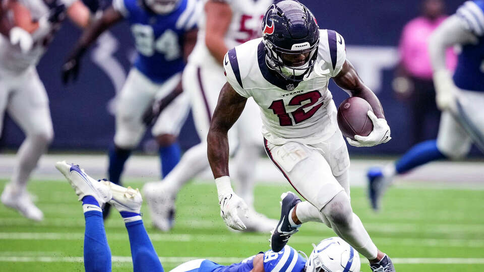 Houston Texans wide receiver Nico Collins (12) breaks away from Indianapolis Colts cornerback JuJu Brents (29) as he runs for a first down on a reception during the second half an NFL football game Sunday, Sept. 17, 2023, in Houston.