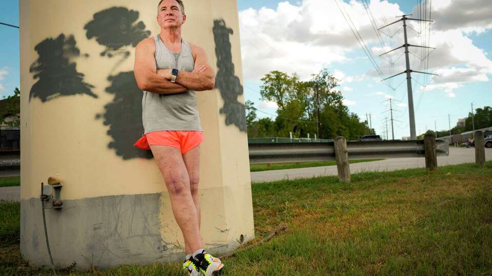 Tim Neckar, who is a long distance runner and a running coach, poses for a portrait on Thursday, Sept. 21, 2023 in Houston. Neckar has just recently returned to running after suffering a devastating knee injury while running in New York City for a 100-mile race in June. The accident happened at mile 12 of the run. He flew home to Houston with his legs in braces, stretched across three seats. Then, he spent three weeks in the braces, unable to bend his legs. After finally being out of the braces and doing physical therapy, he returned to Memorial Park to try walking his old routes.