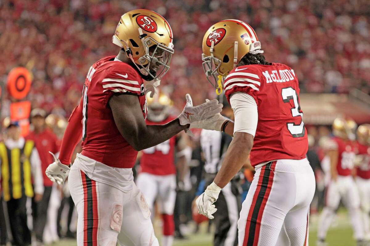 San Francisco 49ers running back Christian McCaffrey (23) and wide receiver Deebo  Samuel (19) celebrate a TD during an NFL football game against the Tampa  Bay Buccaneers, Sunday, Dec.11, 2022, in Santa