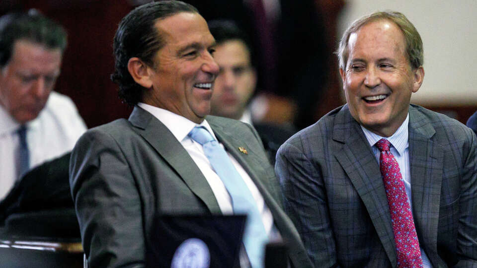 Texas Attorney General Ken Paxton, center, sits between defense attorneys Tony Buzbee, left, and Mitch Little, right, before starting the ninth day of his impeachment trial in the Senate Chamber at the Texas Capitol on Friday, Sept. 15, 2023, in Austin, Texas.