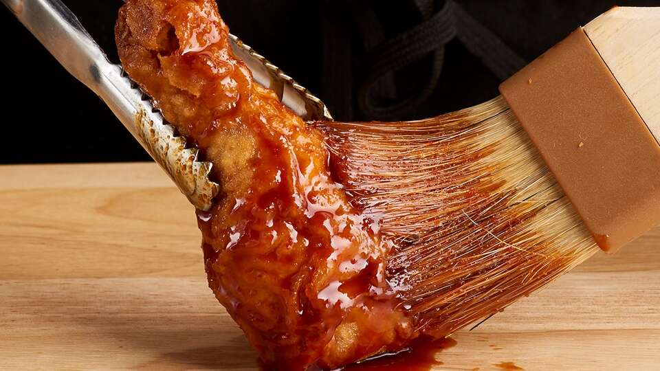 At Bonchon, the preparation is faithful to its South Korean roots. Sauces are brushed onto chicken wings with paint brushes.