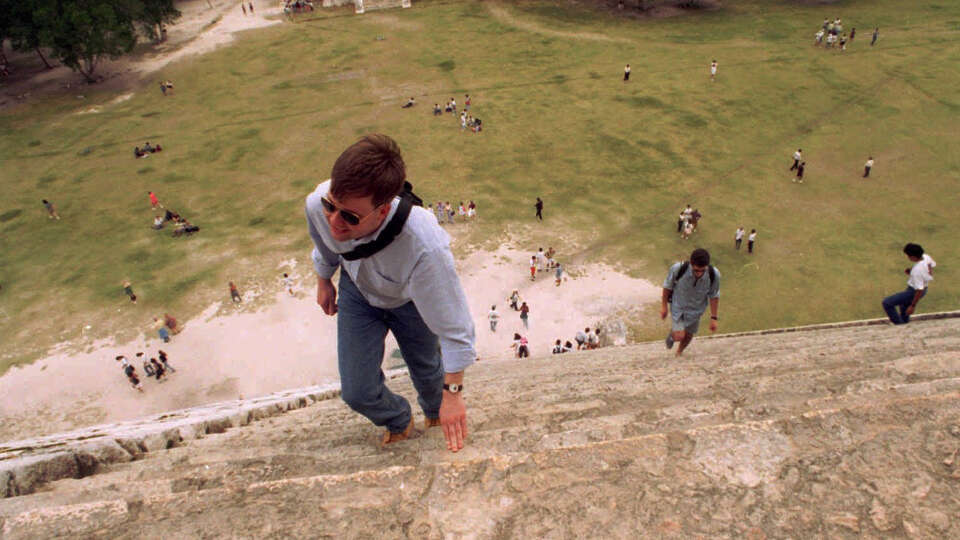 KRT TRAVEL STORY SLUGGED: CANCUN KRT PHOTOGRAPH BY GERRY VOLGENAU/DETROIT FREE PRESS (KRT20-Jan. 20) Tourists climb the perilously steep steps of the 70-foot-high Pyramid of Kukulcan, or El Castillo, at the restored ruin Chichen Itza near Cancun, Mexico. (jdl11213) 1997 (COLOR) HOUCHRON CAPTION (01/25/2004): Tourists climb the steep steps of the 70-foot-high Pyramid of Kukulcan, or El Castillo, at Chichen Itza in Mexico's Yucatan state.