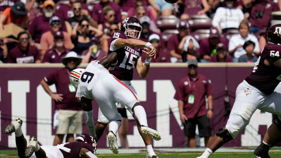 Texas A&M quarterback Conner Weigman (15) is hit after by Auburn linebacker Eugene Asante (9) after throwing a pass down field during the second quarter of an NCAA college football game Saturday, Sept. 23, 2023, in College Station, Texas. (AP Photo/Sam Craft)
