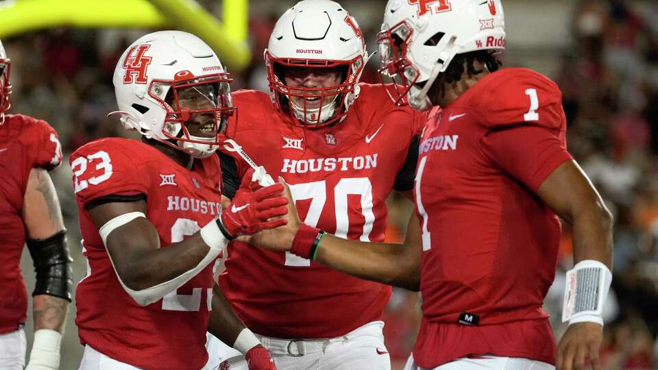 Houston Cougars running back Parker Jenkins (23) celebrates with quarterback Donovan Smith (1) after scoring a touchdown during the second quarter of an NCAA college football game at TDECU Stadium, Saturday, Sept. 23, 2023, in Houston.