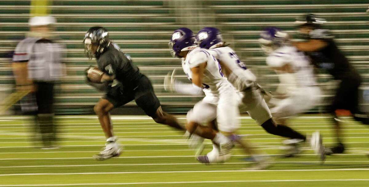 Harlan Hawks G'Ivori Graham (7) eludes Warren defenders in fourth quarter on Saturday, Sept. 23,2023 at Farris Stadium. Harlan defeated Warren 45-7.