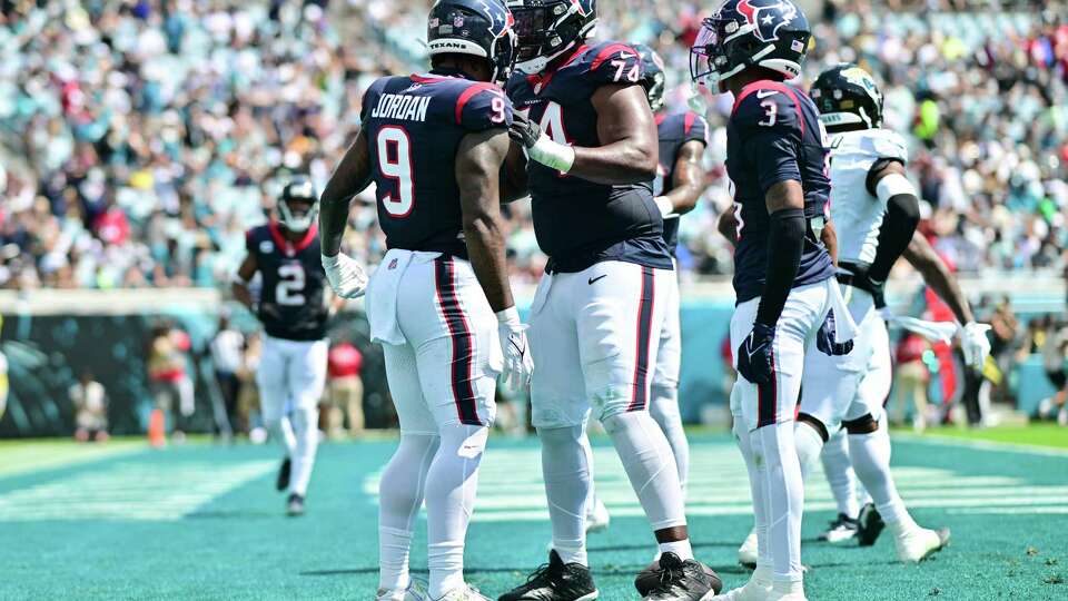 JACKSONVILLE, FLORIDA - SEPTEMBER 24: Brevin Jordan #9 of the Houston Texans celebrates his touchdown with Josh Jones #74 during the second quarter of a game against the Jacksonville Jaguars at EverBank Stadium on September 24, 2023 in Jacksonville, Florida.