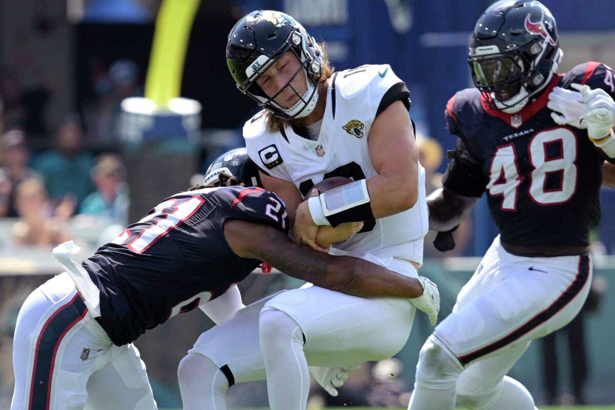 Houston Texans guard Shaq Mason (69) spikes the ball as he celebrates a  touchdown by teammate Dameon Pierce (31) during the first half of an NFL  football game against the Jacksonville Jaguars