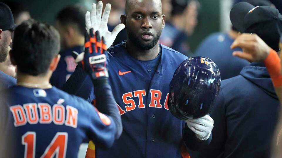 Houston Astros left fielder Yordan Alvarez high fives his teammates in the dugout after hitting a solo home run against the Kansas City Royals during the fifth inning of a Major League Baseball game on Sunday, Sept. 24, 2023, in Houston.