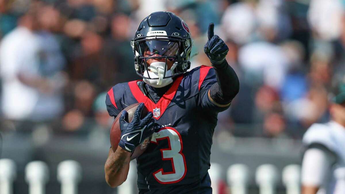 Houston Texans guard Shaq Mason (69) spikes the ball as he celebrates a  touchdown by teammate Dameon Pierce (31) during the first half of an NFL  football game against the Jacksonville Jaguars