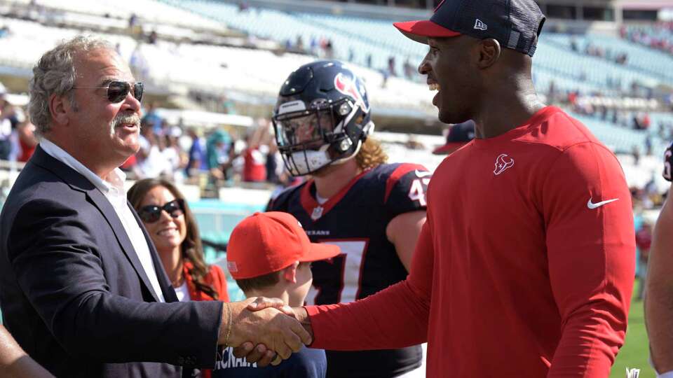 Houston Texans CEO Cal McNair, left, shakes hand with Texans head coach DeMeco Ryans, right, followng an NFL football game against the Jacksonville Jaguars, Sunday, Sept. 24, 2023, in Jacksonville, Fla. (AP Photo/Phelan M. Ebenhack)