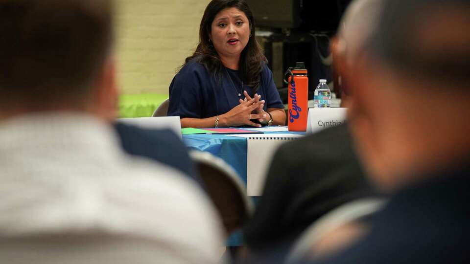 Cynthia Reyes-Revilla, a city council candidate, talks to residents during a District H candidate forum Tuesday, Sept. 26, 2023, at the Proctor Plaza Park Community Center in Houston.