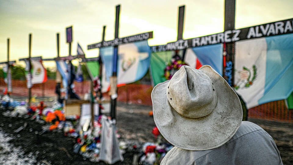 A man pays his respects on Wednesday, July 27, 2022, at the site on Quintana Road where 53 migrants died in a trailer on June 27. The migrants were from Honduras, Mexico and Guatemala. A shrine has been erected on the site.