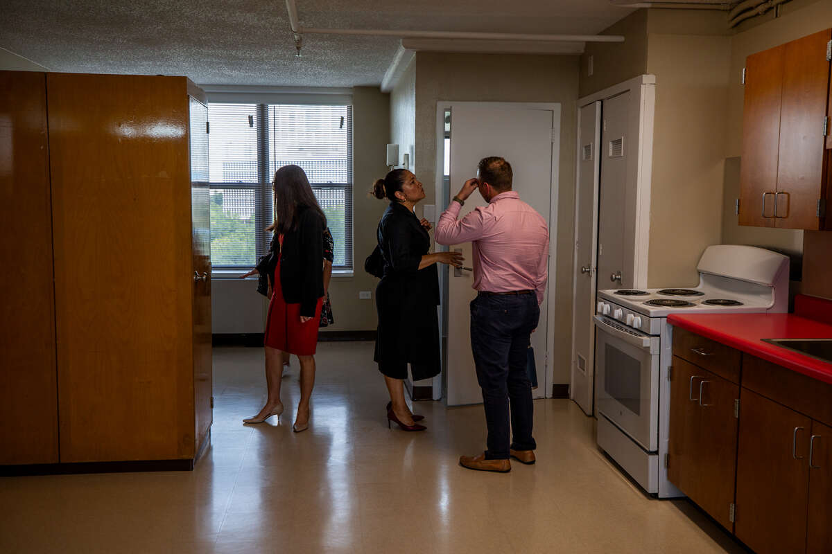 Zuleika Morales-Romero, director of the U.S. Department of Housing and Urban Development’s San Antonio field office, tours a newly remodeled unit at the Victoria Plaza apartments on Sept. 27