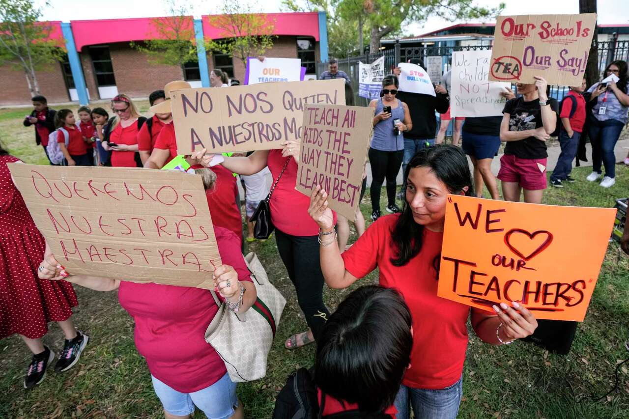 Parents and community members protest outside Cage Elementary and Project Chrysalis Middle School, two New Education System-aligned schools that share the same facility and administration Wednesday, Sept. 27, 2023 in Houston. The protesters chanted for the ouster for state appointed superintendent Mike Miles.