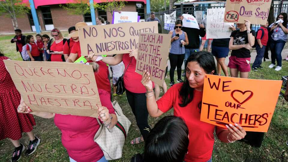 Parents and community members protest outside Cage Elementary and Project Chrysalis Middle School, two New Education System-aligned schools that share the same facility and administration Wednesday, Sept. 27, 2023 in Houston. The protesters chanted for the ouster for state appointed superintendent Mike Miles.