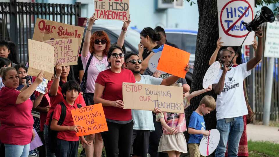 Parents and community members protest outside Cage Elementary and Project Chrysalis Middle School, two New Education System-aligned schools that share the same facility and administration Wednesday, Sept. 27, 2023 in Houston. The protesters chanted for the ouster for state appointed superintendent Mike Miles.