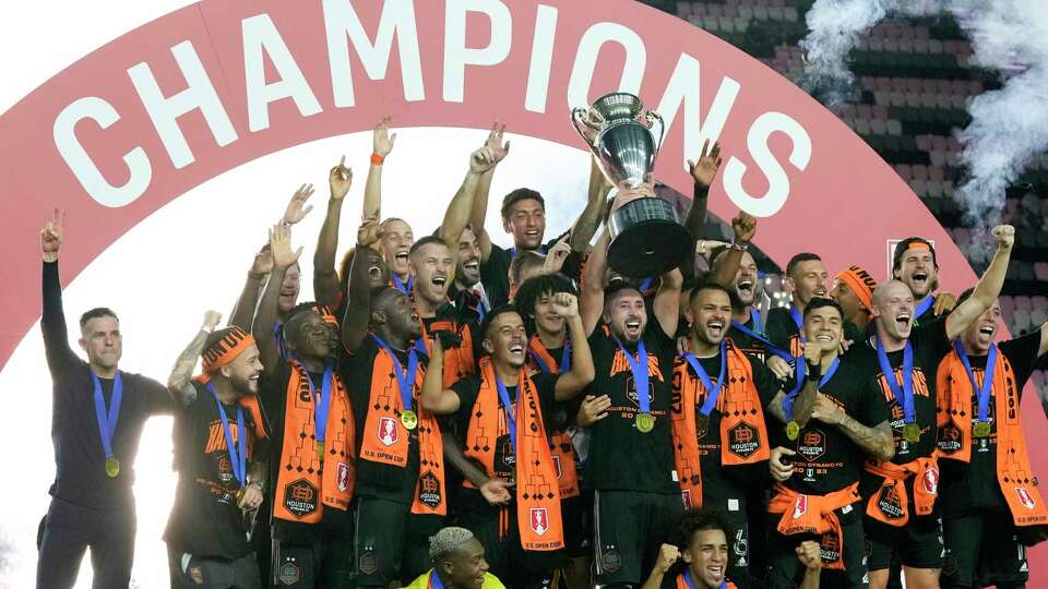 Houston Dynamo players and head coach Ben Olsen, left, raise the trophy after winning the U.S. Open Cup final soccer match against Inter Miami, Wednesday, Sept. 27, 2023, in Fort Lauderdale, Fla. (AP Photo/Rebecca Blackwell)