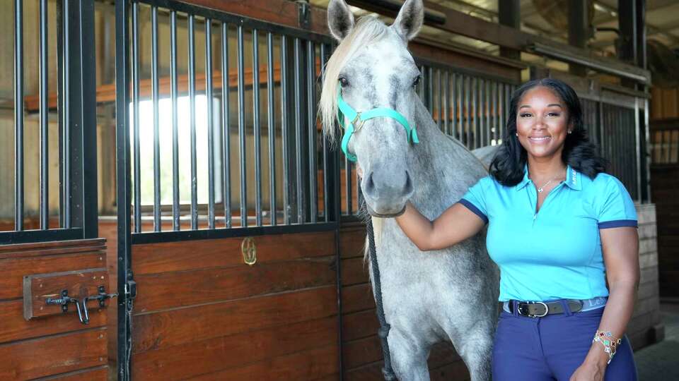 LeBrina Jackson with a horse named Barbie's World at her ranch Thursday, Sept. 28, 2023, in Hockley.
