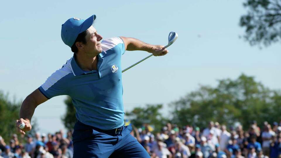 Europe's Viktor Hovland throws his ball to the crowd after winning his with playing partner Europe's Ludvig Aberg on the 15th green 4&3 morning Foursome match at the Ryder Cup golf tournament at the Marco Simone Golf Club in Guidonia Montecelio, Italy, Friday, Sept. 29, 2023.