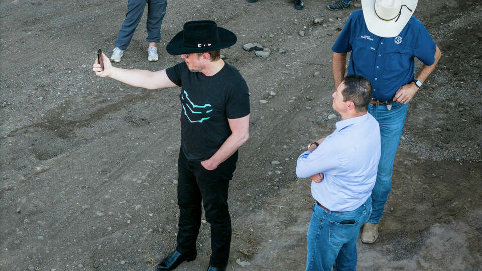 EAGLE PASS, TEXAS - SEPTEMBER 28: An aerial view of tech entrepreneur Elon Musk, wearing a black Stetson hat, livestreaming while visiting the Texas-Mexico border on September 28, 2023 in Eagle Pass, Texas. Musk toured the border along the bank of the Rio Grande with Rep. Tony Gonzales (R-Texas) to see firsthand the ongoing migrant crisis, which he has called a 