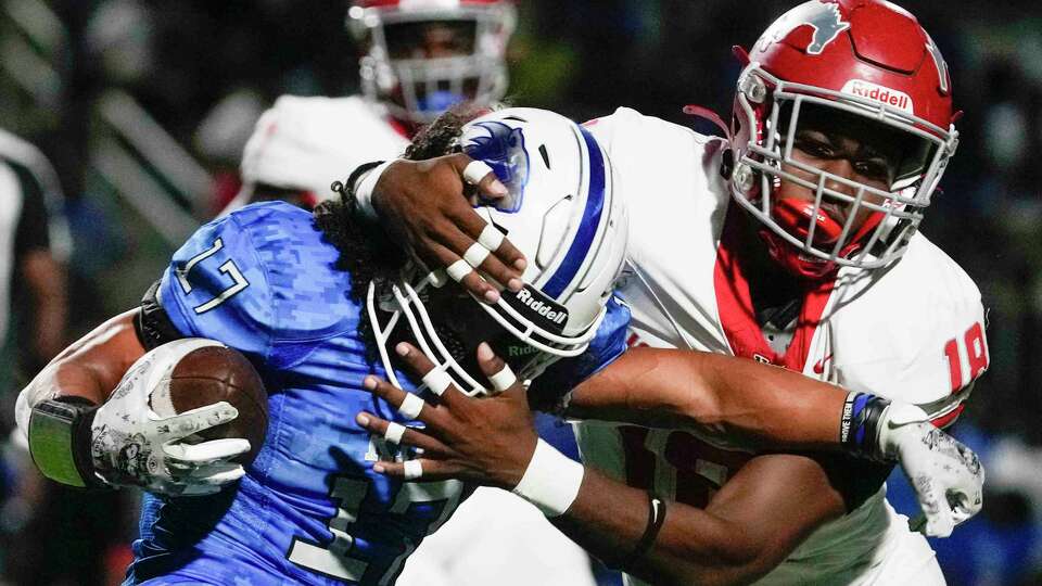 C.E. King wide receiver Rae'G Dailey (17) is tackled by North Shore defensive back Paul Porter (17) during the first quarter of a District 21-6A high school football game at Panther Stadium, Friday, Sept. 29, 2023, in Houston.