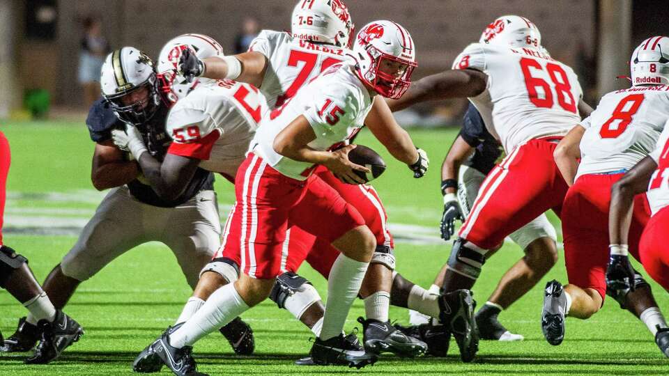 Katy's Gunner Nelson (15) prepares to handoff to Tremayne Hill (40) in the first half against Jordan of a high school football game at Legacy Stadium, Friday, Sep. 29, 2023 in Katy.