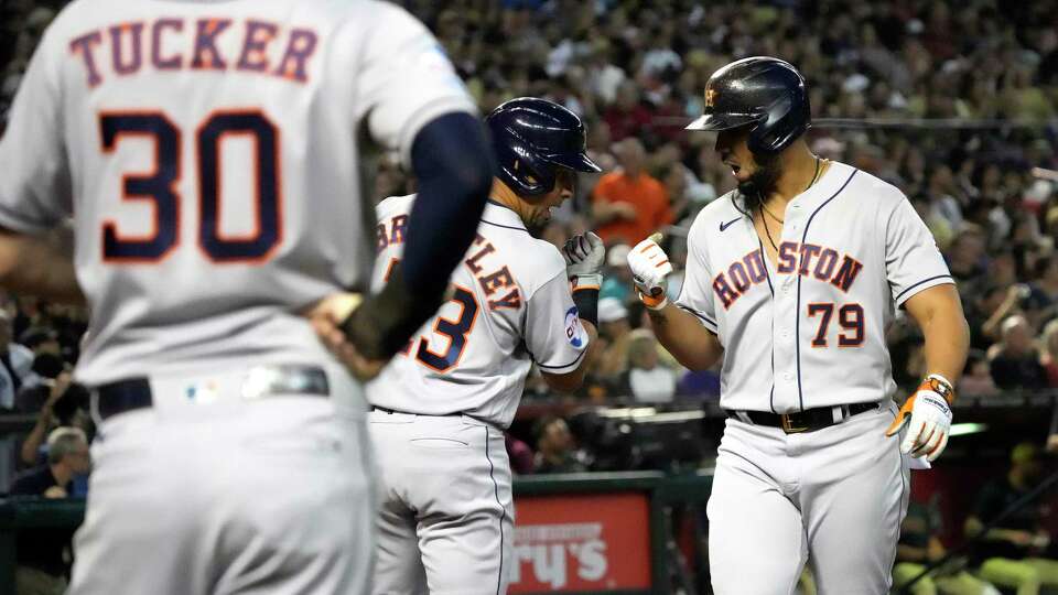 Houston Astros Jose Abreu (79) celebrates with Michael Brantley (23) after what he thought was a three-run home run but was challenged and turned into a ground-rule double that scored two runs during the sixth inning of a MLB baseball game at Chase Field on Friday, Sept. 29, 2023 in Phoenix.