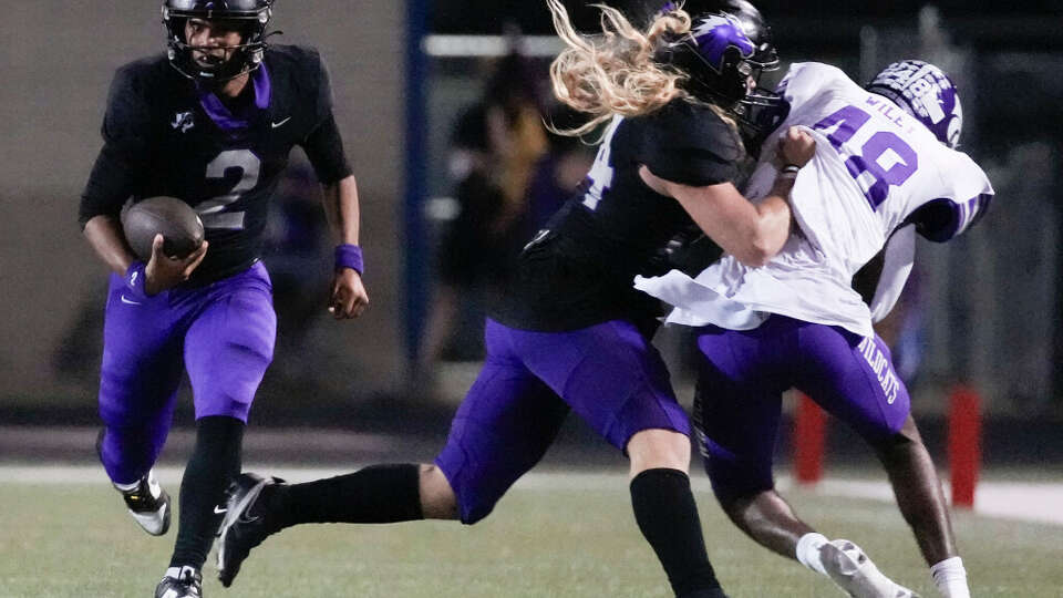 Fulshear quarterback Deuce Barrington (2) picks up a first down as fullback Zane Smith blocks during the third quarter of a District 10-5A (Div. I) high school football game at Traylor Stadium, Thursday, Sept. 28, 2023, in Rosenberg.