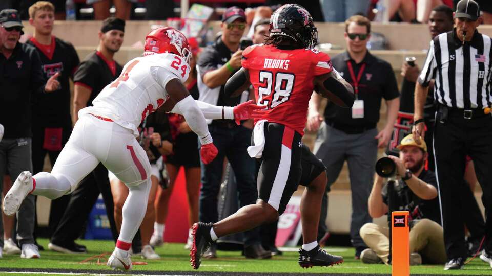 LUBBOCK, TEXAS - SEPTEMBER 30: Tahj Brooks #28 of the Texas Tech Red Raiders rushes for a touchdown during the first quarter against the Houston Cougars at Jones AT&T Stadium on September 30, 2023 in Lubbock, Texas.