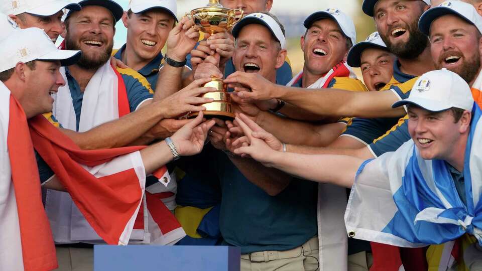 The Europe team led by Europe's Team Captain Luke Donald, at center, lift the Ryder Cup after winning it at the Marco Simone Golf Club in Guidonia Montecelio, Italy, Sunday, Oct. 1, 2023.