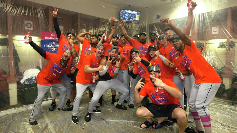 Houston Astros take a group photo as they celebrated in the clubhouse after clinching the AL West title in an 8-1 win against the Arizona Diamondbacks during a MLB baseball game at Chase Field on Sunday, Oct. 1, 2023 in Phoenix.