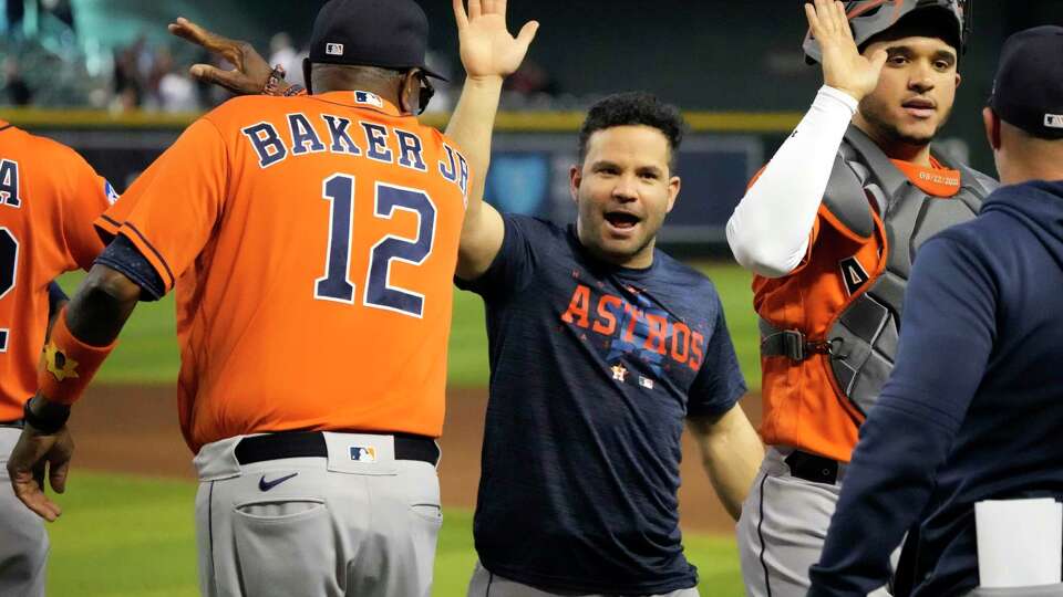 Houston Astros second baseman Jose Altuve (27) and manager Dusty Baker Jr. (12) celebrated after clinching the AL West title in an 8-1 win against the Arizona Diamondbacks of a MLB baseball game at Chase Field on Sunday, Oct. 1, 2023 in Phoenix.