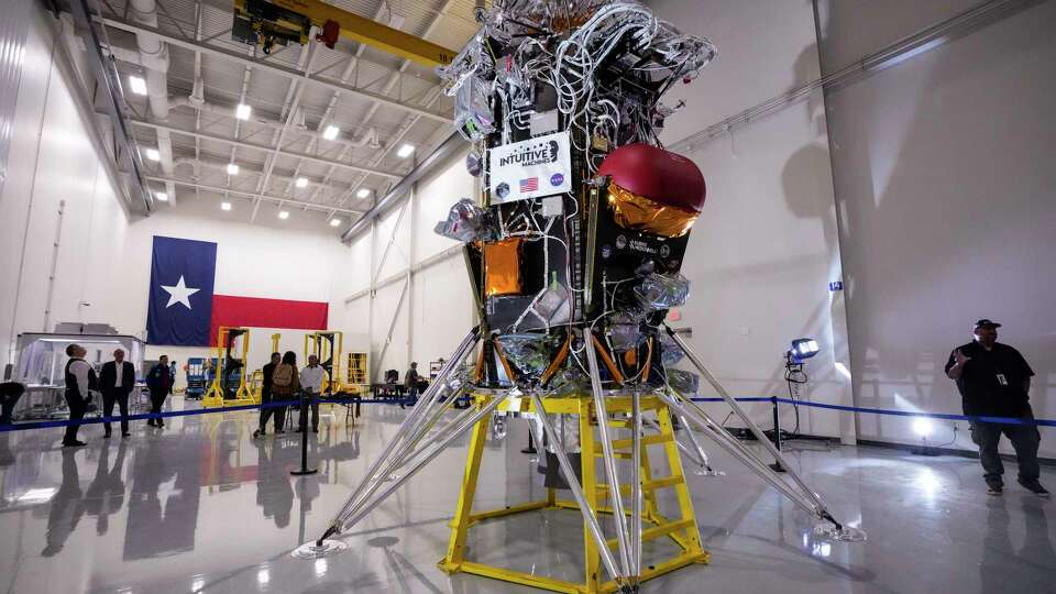 People gather around the Nova-C lunar lander at Intuitive Machines on Monday, Oct. 2, 2023 in Houston. The lander was put on display during a media open house before being shipped to Florida for a November launch to the moon.