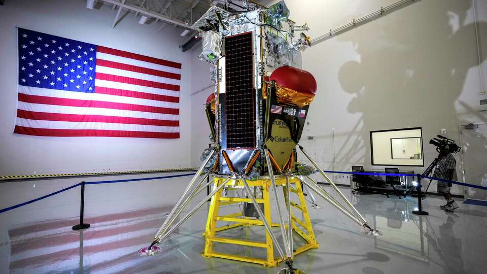 People gather around the Nova-C lunar lander at Intuitive Machines on Monday, Oct. 2, 2023, in Houston. The lander was put on display during a media open house before being shipped to Florida for a November launch to the moon.