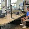 Brad Tunney, left, and Ben Bosscher host the first episode of the local sports talk show "The Payoff" in the studios of the newly rebranded Sports Radio 100.9 FM The Mitt" at Dow Diamond in Midland on Oct. 2, 2023.