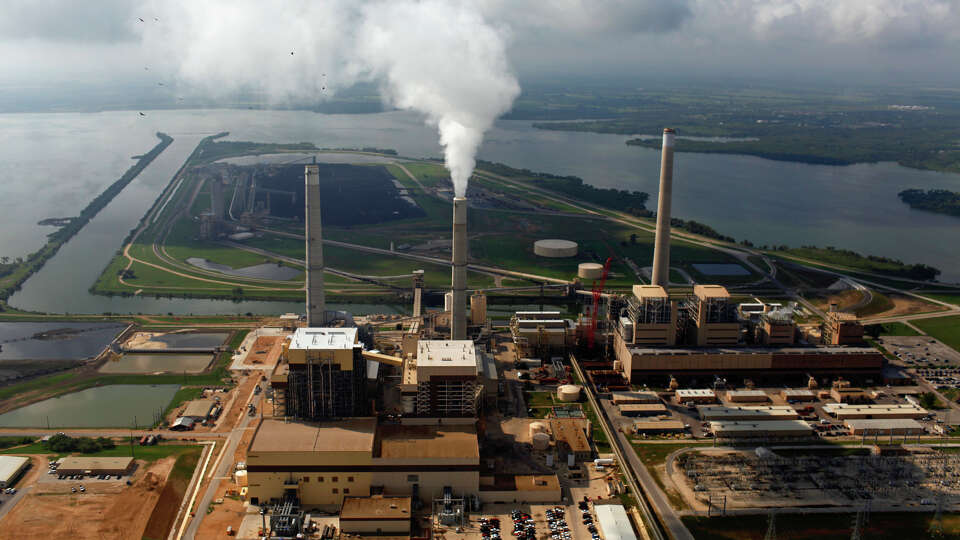 CPS Energy's coal plants Spruce 2, left, Spruce 1, center, and Deely are seen on Calaveras Lake in 2010. 
