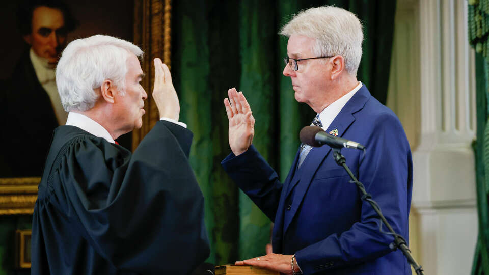 Nathan Hecht, justice of Texas Supreme Court, swears in Lt. Gov. Dan Patrick before the first day of Texas Attorney General Ken Paxton's impeachment trial in the Texas Senate chambers at the Texas State Capitol in Austin on Tuesday, Sept. 5, 2023. The Texas House, including a majority of its GOP members, voted to impeach Paxton for alleged corruption in May. (Juan Figueroa/Pool via The Dallas Morning News)