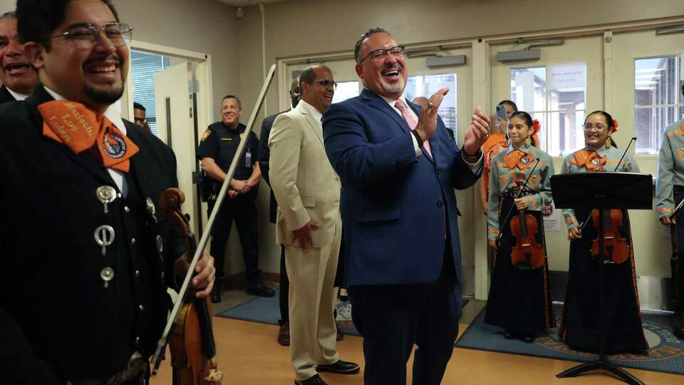 U.S. Secretary of Education Miguel Cardona reacts after hearing the Mark Twain Dual Language Academy mariachi band, Wednesday, Oct. 4, 2023. Cardona toured the school, visiting three classrooms and meeting with staff and parents. On the left is mariachi teacher, Raymond Nieto.