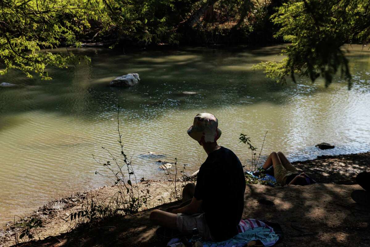 Richard Grau, center, and his classmates participate in a forest bathing exercise led by Trinity University professors Laura Allen and Courtney Crim during a Sept. 29 field trip to the Guadalupe River State Park.