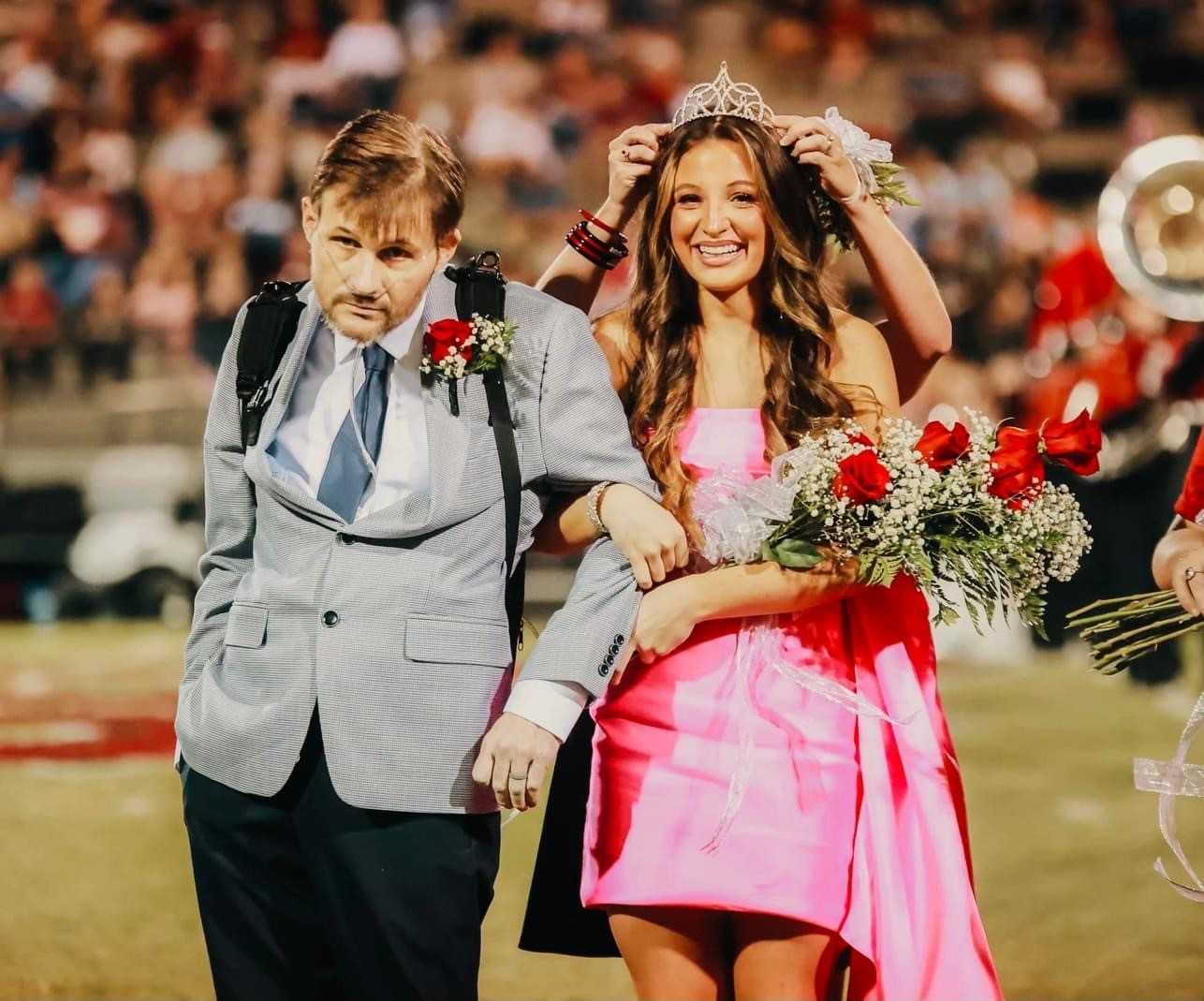 Father fighting cancer escorts daughter as she wins homecoming crown