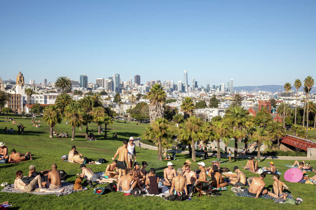 People hang out in Dolores Park in San Francisco, Calif. during a warm weather day on October 4, 2023.