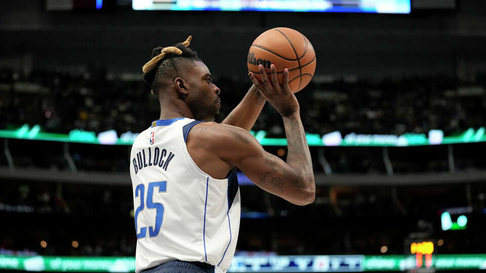 Dallas Mavericks forward Reggie Bullock takes a shot during an NBA basketball game against the Chicago Bulls, Friday, April 7, 2023, in Dallas. (AP Photo/Tony Gutierrez)