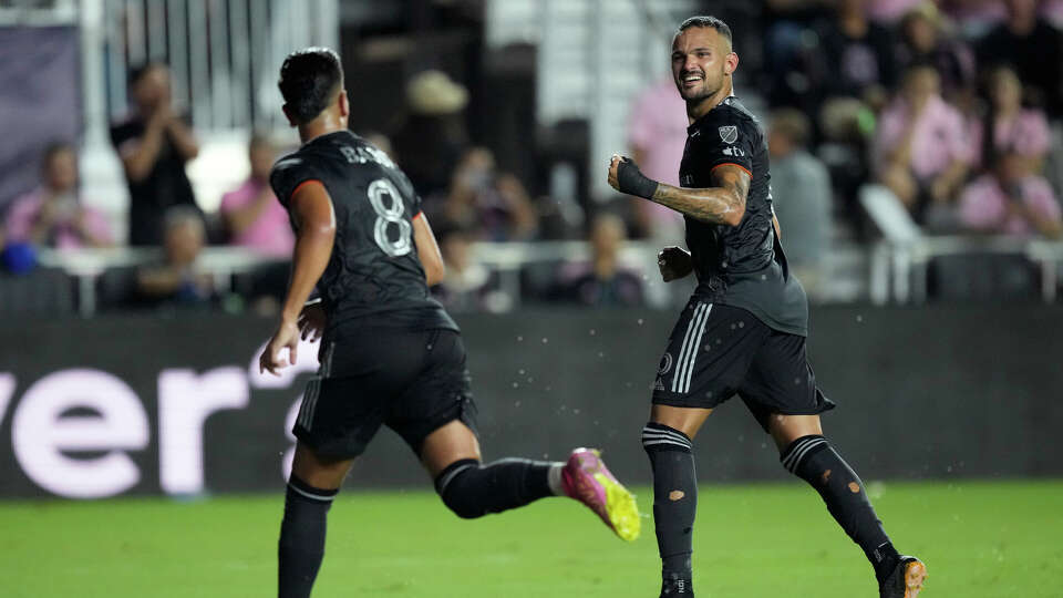 Houston Dynamo midfielder Artur, right, celebrates after Houston Dynamo midfielder Amine Bassi (8) scored on a penalty in the first half of the U.S. Open Cup final soccer match against Inter Miami, Wednesday, Sept. 27, 2023, in Fort Lauderdale, Fla. (AP Photo/Rebecca Blackwell)