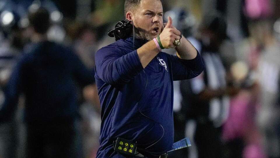 College Park head coach Kyle Coats gives a thumbs ups after the teamÕs touchdown during the first half of a high school football game against Willis, Thursday, Oct. 5, 2023, in The Woodlands.