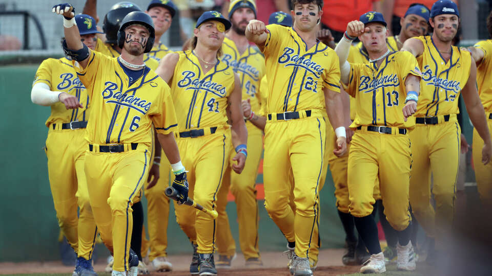 Savannah Bananas' Ryan Cox (6) leads his teammates as they dance to home plate before a Cox at bat during baseball game at Excite Ballpark in San Jose, Calif., on Tuesday, July 25, 2023.