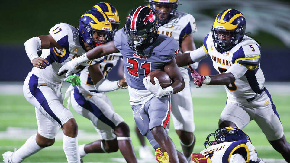 Westfield running back Taji Atkins (21) runs for extra yards in the first half of a District 14-6A football game between the Nimitz Cougars and the Westfield Mustangs at Planet Ford Stadium in Spring, TX on Friday, October 6, 2023.