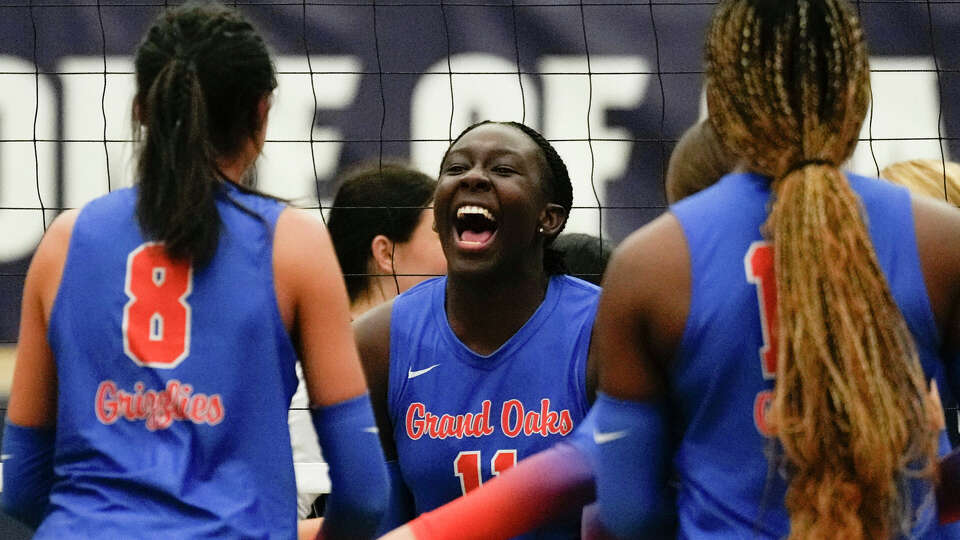 Grand Oaks middle blocker Jaela Auguste (11) reacts after a block during the first set of a District 13-6A high school volleyball match at College Park High School, Tuesday, Sept. 26, 2023, in The Woodlands.